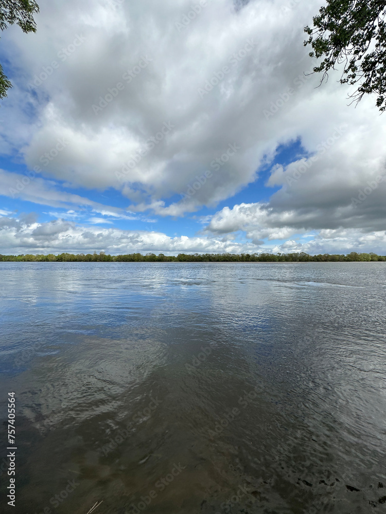 Clouds reflected at Loire river in the Loire valley in France, Europe
