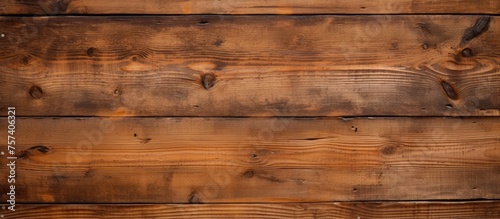 A detailed close up of a brown hardwood plank flooring with a grainy texture, showcasing the natural beauty of the wood grain and amber tones