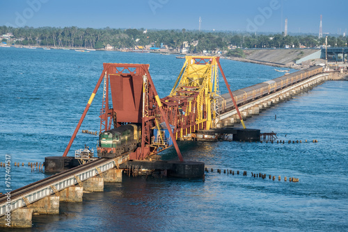 Indian Railways passenger train crossing historical , 2 kms long Pamban sea bridge. photo