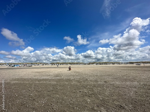 a person is walking on a beach on a cloudy day