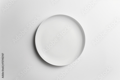 Minimalist white plate on a plain background