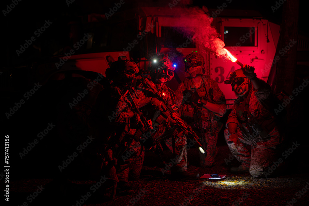 Fototapeta premium Group of soldiers in camouflage uniforms hold weapons with patrol missions at night