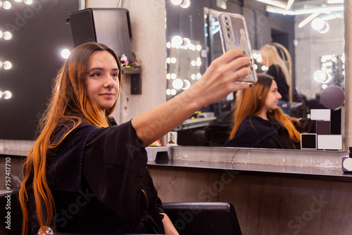 Woman capturing her new hairstyle at the salon photo