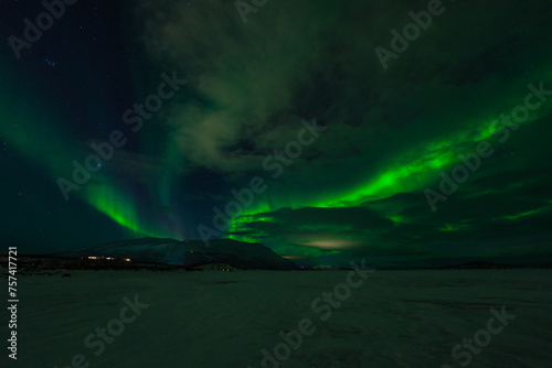 Aurora Borealis - Northern lights - above frozen lake Tornetrask in Abisko, Sweden