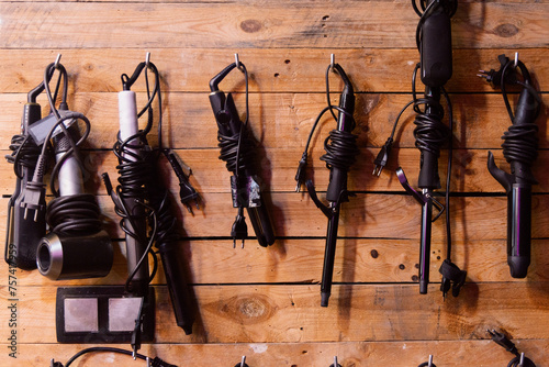 Professional hair styling tools organized on a wall photo