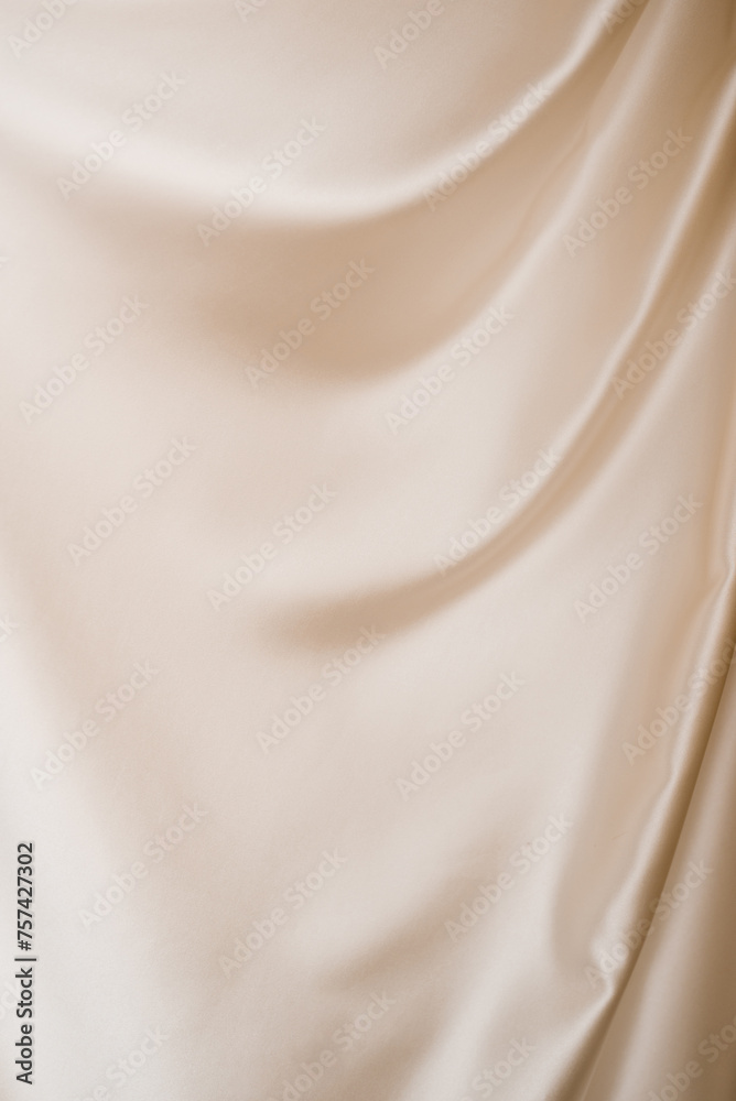Beige fabric with waves. The fabric is long and flowing. The image creates a calm and serene mood