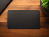 Mockup of black business paper card with rounded corners on workspace desk background