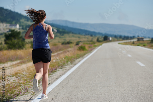 A determined woman athlete trains for success in the morning sun.