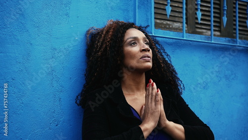 Canvas-taulu One worried hispanic black woman seeking solace during hard times Praying to GOD