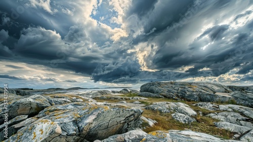 A dramatic sky with dark, rolling clouds over a rocky landscape, creating a mood of impending storm.