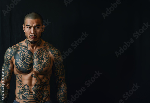 Handsome muscular Traditional yakuza member with his body entirely tattooed. With copy space for text. Gang member of the traditional Japanese mafia.