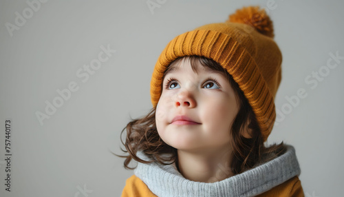 Child in Mustard Beanie Looking Up