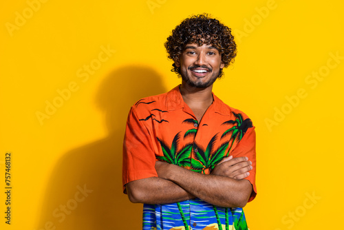 Portrait of cool cheerful guy with afro hairstyle wear print shirt holding arms crossed isolated on vibrant yellow color background