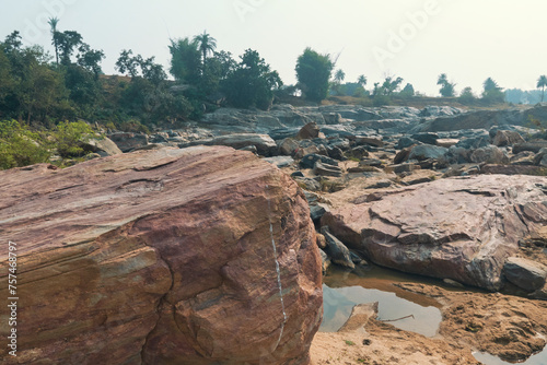 flow of Telwa river stream falling through levels of rocky terrain at Dharhara falls in Simultala, Bihar. Water level is knee-deep as flow of water is mostly dried-up in winter season. photo