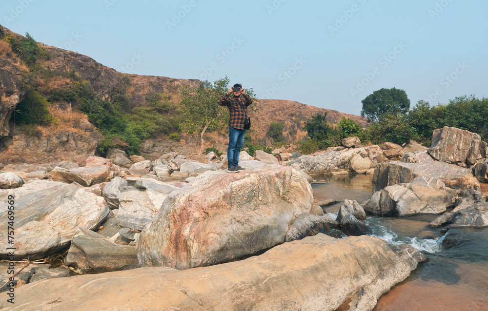 flow of Telwa river stream falling through levels of rocky terrain at Dharhara falls in Simultala, Bihar. Water level is knee-deep as flow of water is mostly dried-up in winter season. flow of Telwa river stream falling through levels of rocky terrain at Dharhara falls in Simultala, Bihar. Water level is knee-deep as flow of water is mostly dried-up in winter season.