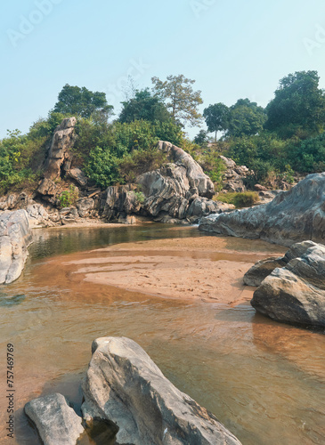 flow of Telwa river stream falling through levels of rocky terrain at Dharhara falls in Simultala, Bihar. Water level is knee-deep as flow of water is mostly dried-up in winter season.