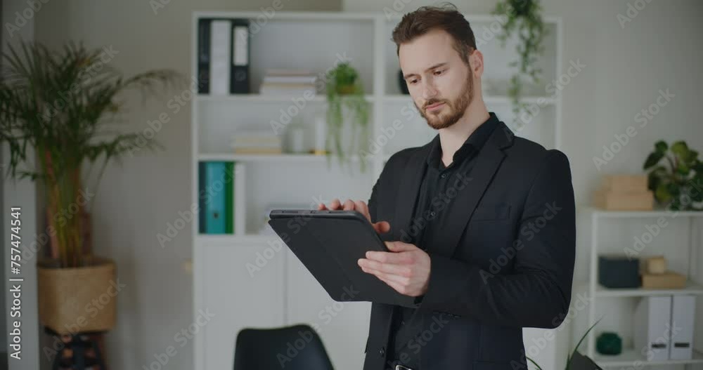 Handsome young male professional using digital tablet Handsome young male professional using digital tablet