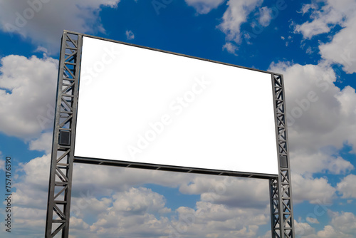 Mock up: blank white billboard or large display against the blue sky with white clouds. Mockup, copy space, advertising, template, white screen and consumerism concept