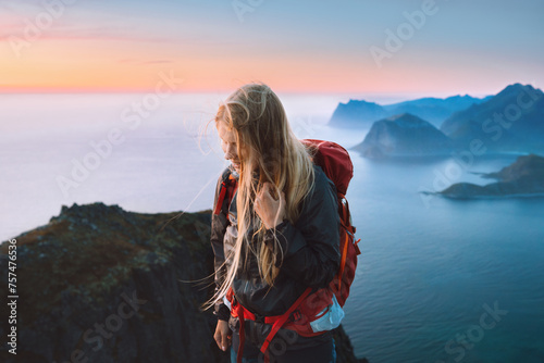 Woman traveling alone in Norway girl traveler hiking in mountains of Lofoten islands outdoor activity healthy lifestyle summer vacations adventure eco tourism happy emotions