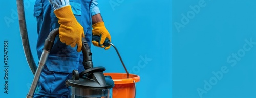 Cleaning worker in uniform with equipment on monotonous background. banner, space for text, cleaning service
