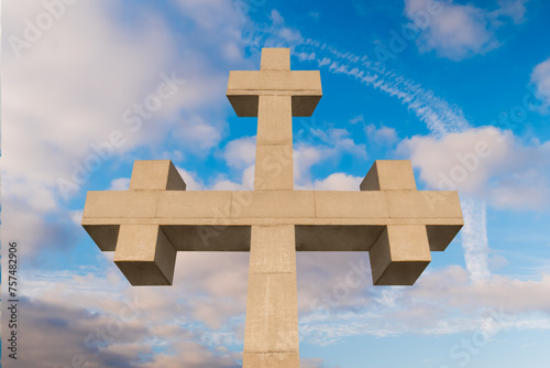 Front view of huge stone cross monument against white clouds, located on the mountain over Gonio town near Batumi, Georgia. Orthodoxy, spiritual, cloudscape, Christianity and religion concept photo