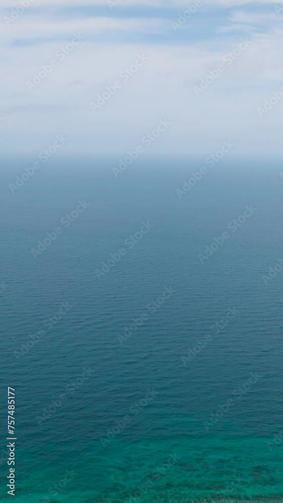 Tropical sea waves and corals. Blue sea in Santa Fe, Tablas, Romblon. Philippines. Vertical view. Tropical sea waves and corals. Blue sea in Santa Fe, Tablas, Romblon. Philippines. Vertical view.