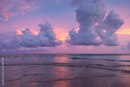 Pink sky with clouds and ocean. Sunset scenery. Bali island, Indonesia. Wallpaper background. Natural scenery. Romantic relax place.
