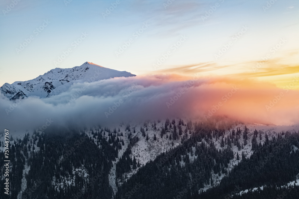 Winter. Sunrise. A panoramic view of the covered with snowy mountain peak. Natural landscape with beautiful sky. Location place Carpathian, Ukraine, Europe.