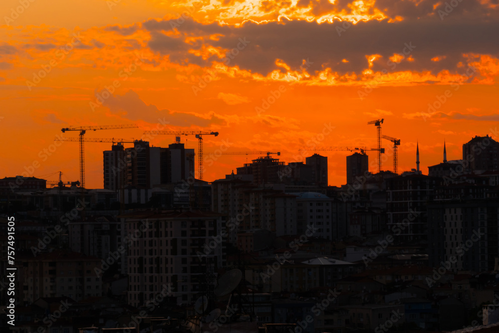 Dramatic sunset sky with the setting sun over the city of Istanbul, Turkey in the evening - apartment, residential buildings silhouettes. Urban, industrial, cityscape and summer concept