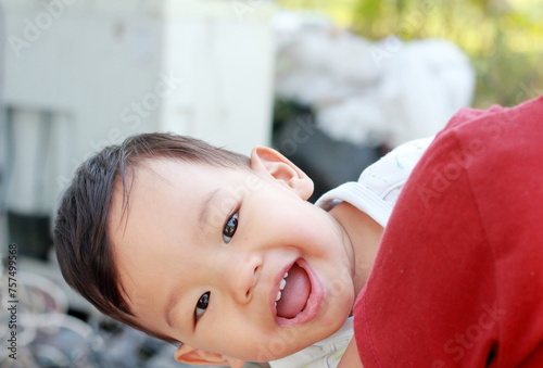 Portrait of a cute boy Cute 2 year old Asian looks cheekily and Teasing with smiling and looking at camera photo