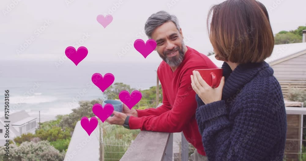 Animation of hearts over diverse couple drinking coffe on balcony Animation of hearts over diverse couple drinking coffe on balcony