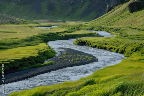 Peaceful River Winding Through A Green Valley © SaroStock