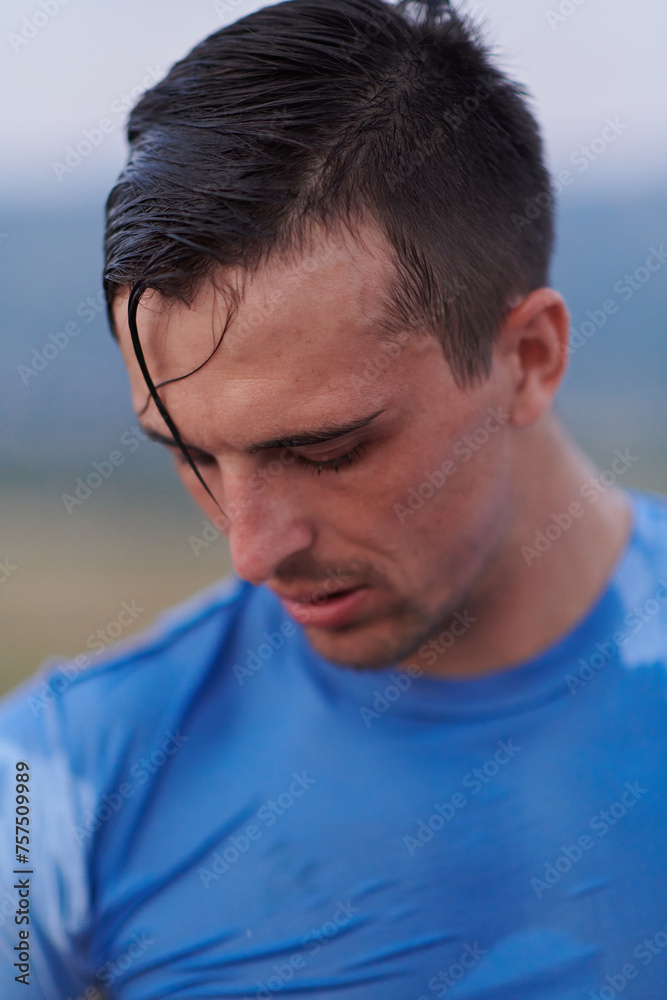 Fototapeta premium Post-Run Repose: Sweaty Athlete Rests After Intense Daily Run.