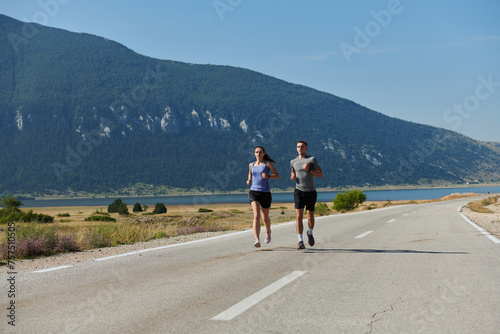 Energized by the beauty of nature  a couple powers through their morning run  their bodies and spirits invigorated.