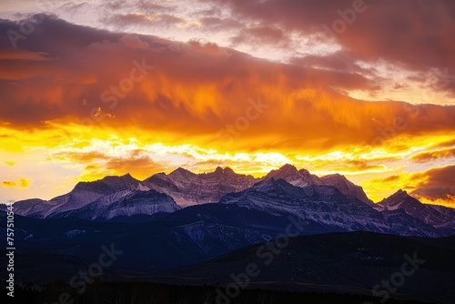 A stunning sunrise over majestic mountains, painting the sky with vibrant golden hues. The peaks outlined against the dawn, a serene and inspiring landscape