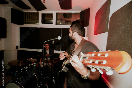 Male musicians performing in a cozy venue setting photo