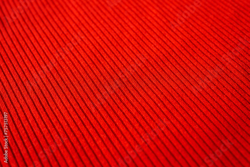 Close-up of red fabric texture with visible threads and patterns. Macro shot for fashion industry, interior design, and crafting.