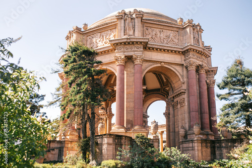 The grandeur of San Francisco's Palace of Fine Arts is showcased on a clear spring day, with lush greenery framing its classical architecture