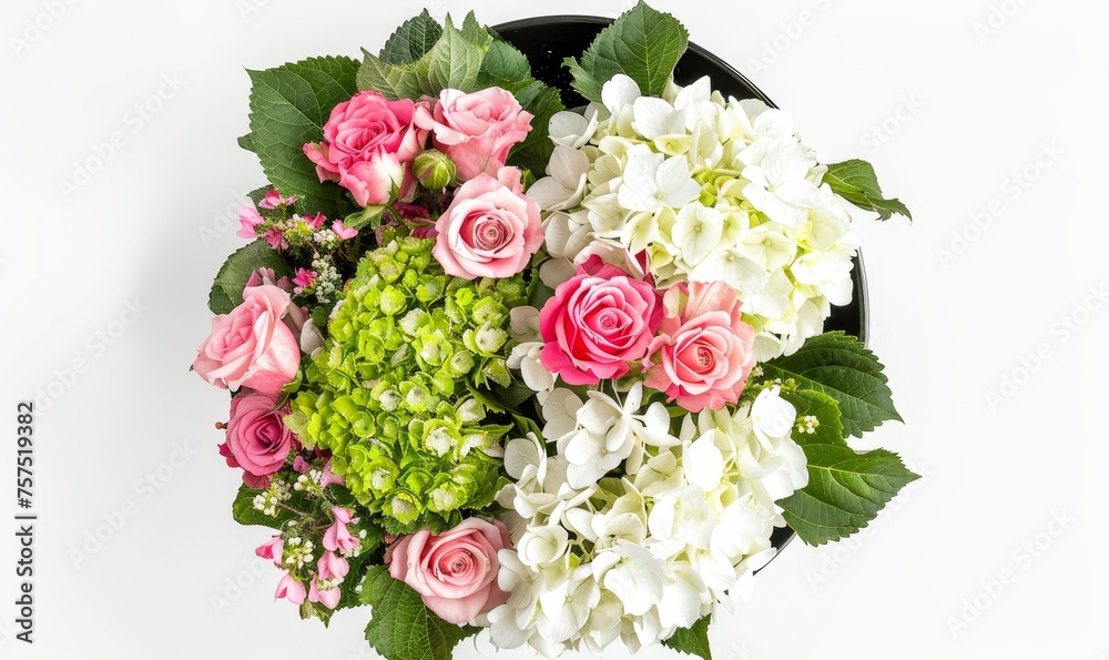 Overhead view of a mixed floral arrangement with pink roses and white hydrangeas against a white background. Concept card happy birthday, cover, advertising a bouquet in a flower shop.