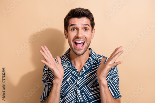 Photo of overjoyed cheerful guy celebate success rejoice special black friday offer sale isolated on beige color background photo