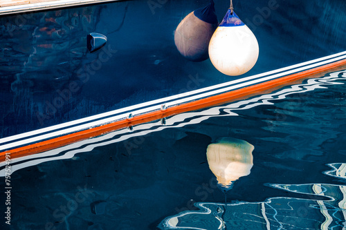 fenders suspended between a boat and dockside for protection. Maritime fenders beautiful background.