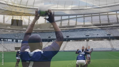 Animation of flag of uruguay over african american rugby player thowing ball to team at stadium photo