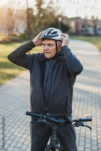 Older Man Holding Helmet on Bike