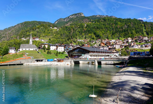 Touristic view of Alleghe resort in the italian Dolomites on bright autumn day, Europe photo