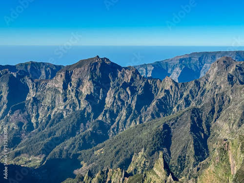 Scenic view of mountain ridges and majestic canyon of rugged terrain on Madeira island  Portugal  Europe. Idyllic hiking trail to mountain peak Pico Ruivo. Coastal landscape on sunny day. Tranquility