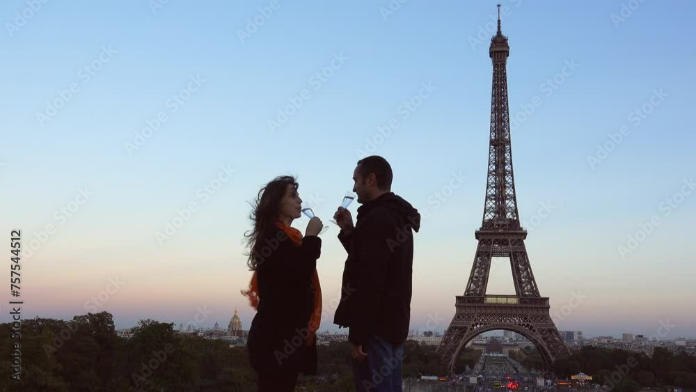 Romantic couple drinking sparkling wine in front of Eiffel Tower Paris