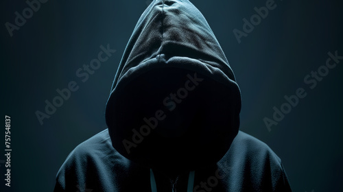 Silhouetted figure in hoodie against digital background photo