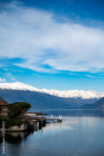 Fototapeta Naklejka Na Ścianę i Meble -  Driving car along shores of Lake Como in Northern Italy, spring sunny days, views of alpine mountains, water and villages