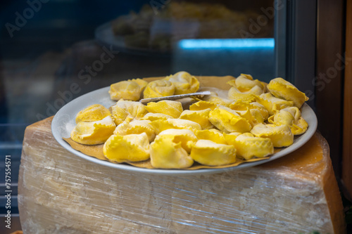 Italian food, fresh homemade stuffed pasta tortelli or ravioli dumplings ready to cook, Milan, Lombardy, Italy photo