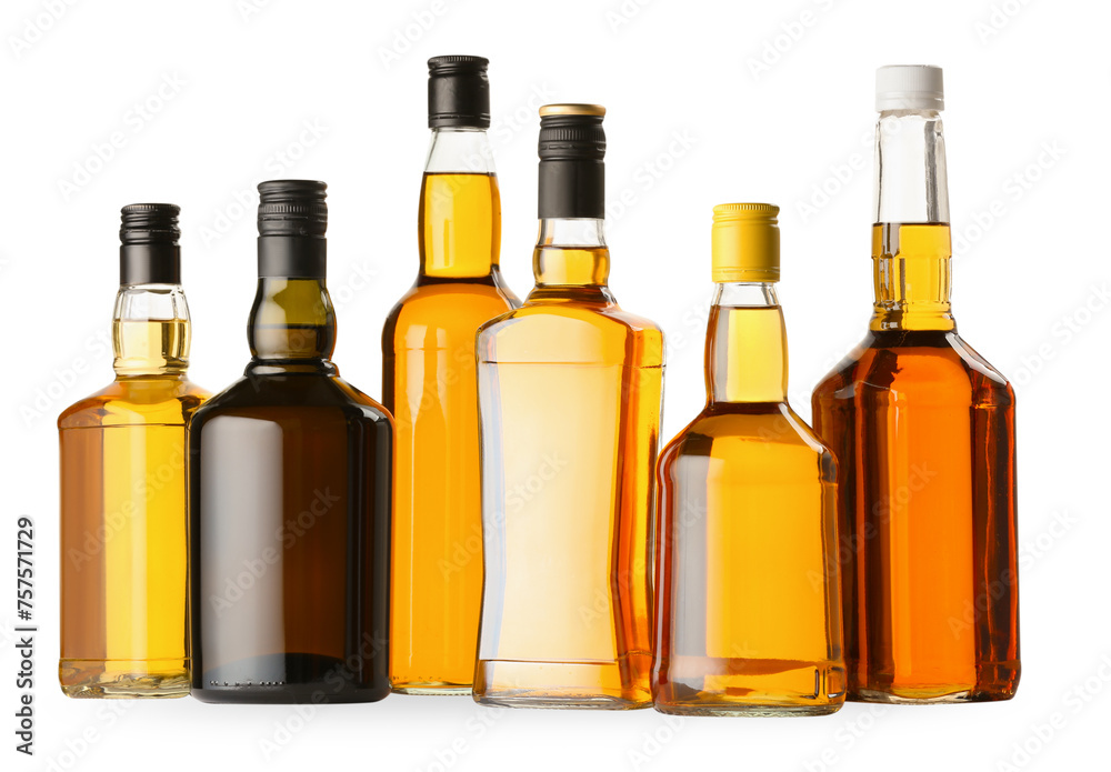 Different sorts of whiskey in glass bottles isolated on white Different sorts of whiskey in glass bottles isolated on white